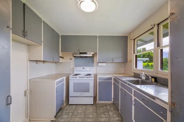 a view of a kitchen with a sink and a stove top oven