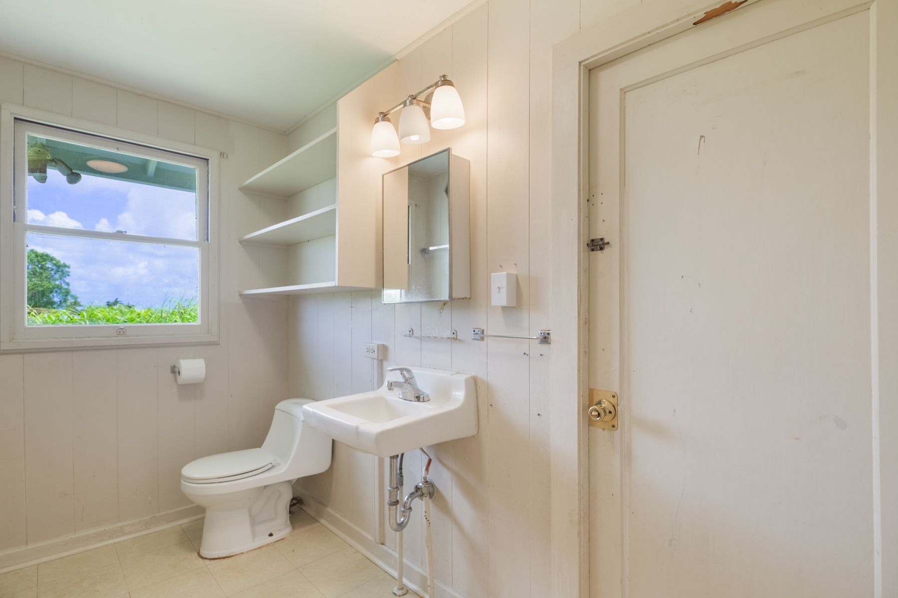 6151 Kawaihau Road Kapaa, HI 96746 - Photo 25 of 30 a bathroom with a toilet a sink and mirror