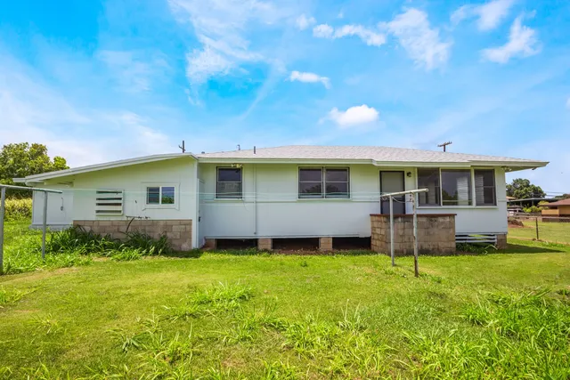 a view of a house with a backyard