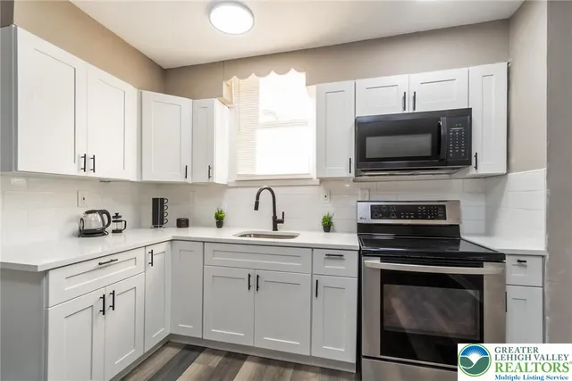 a kitchen with a sink stove and microwave