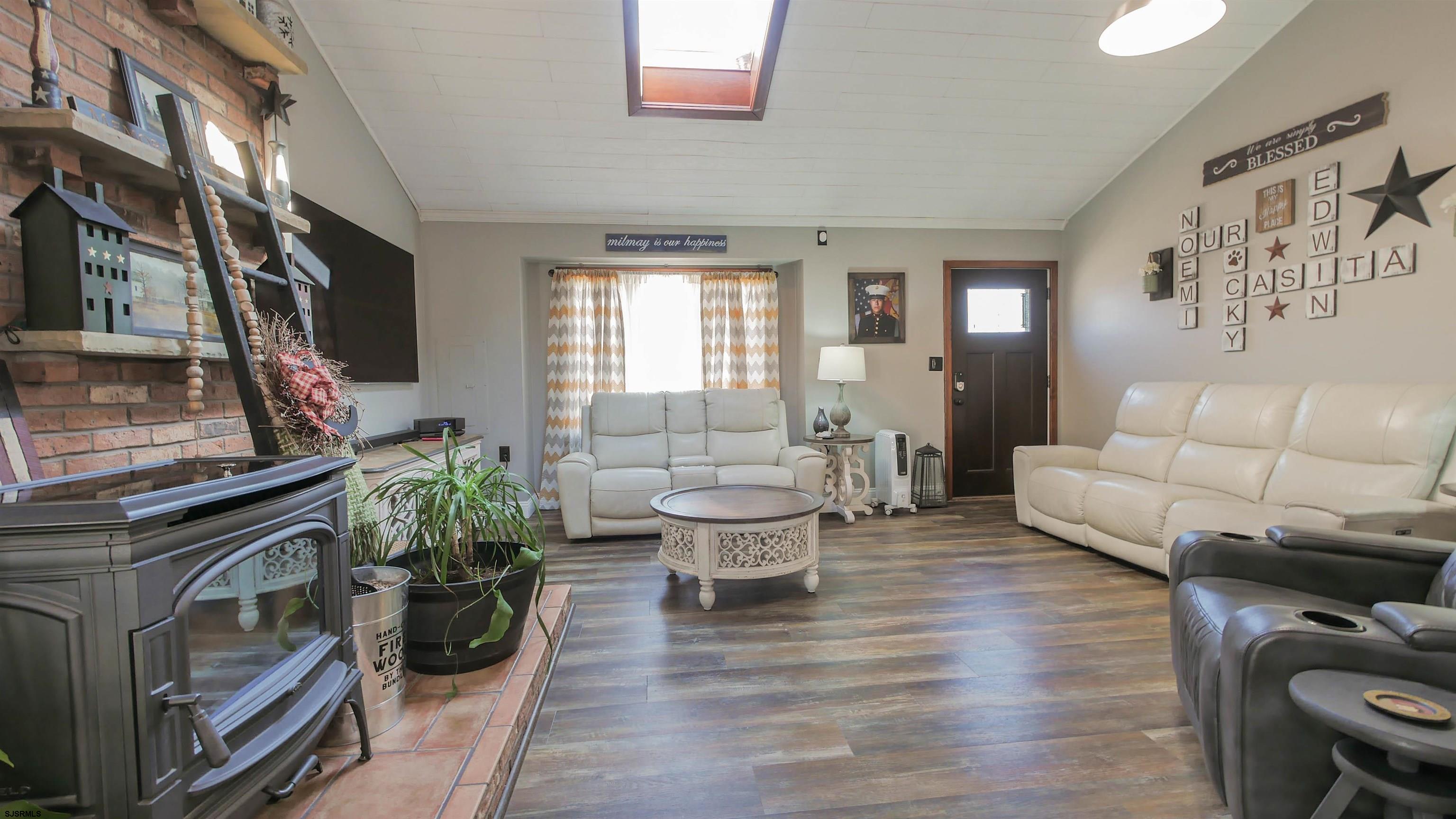 337 Broad Street Milmay, NJ 08330 - Photo 15 of 36 a living room with furniture and a fireplace