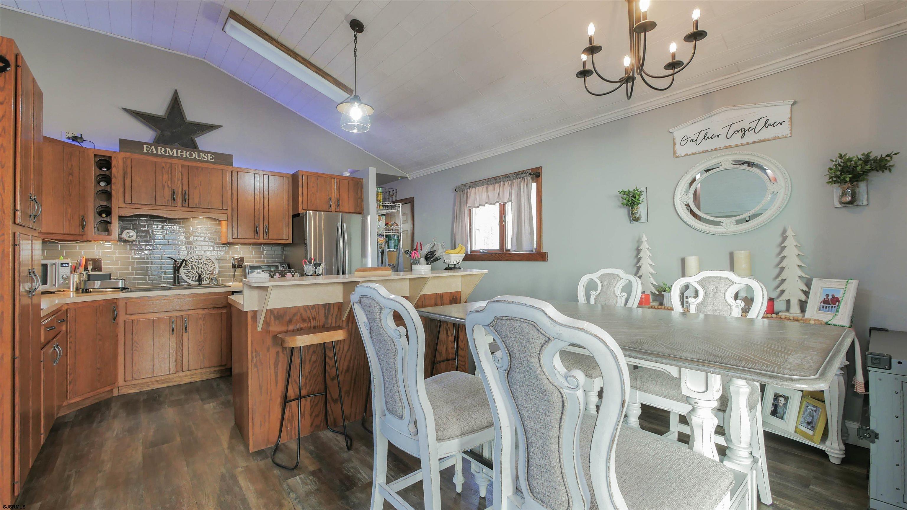 337 Broad Street Milmay, NJ 08330 - Photo 18 of 36 a kitchen with stainless steel appliances granite countertop a table chairs a microwave a sink and cabinets