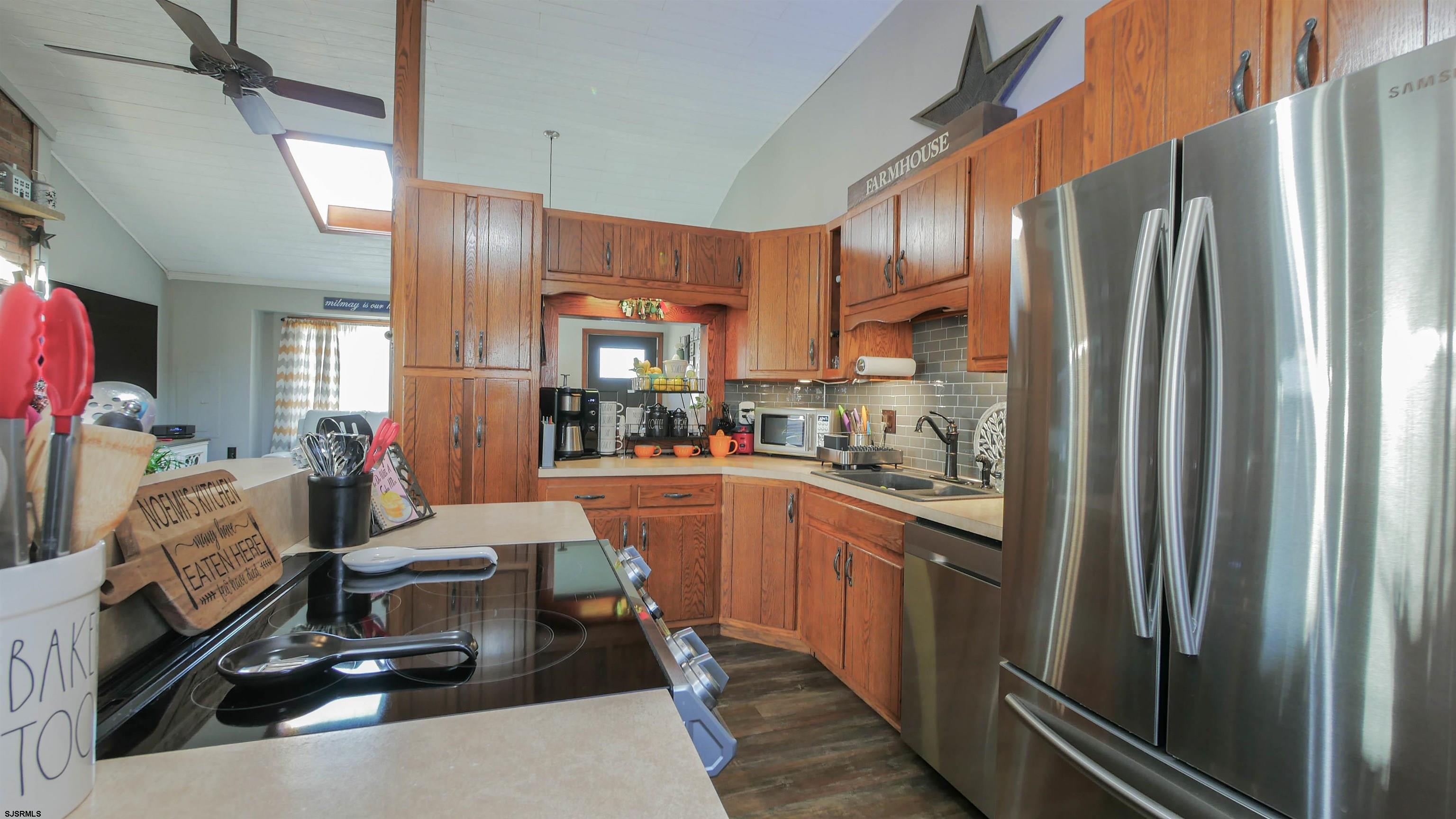 337 Broad Street Milmay, NJ 08330 - Photo 19 of 36 a kitchen with stainless steel appliances granite countertop a refrigerator and a sink
