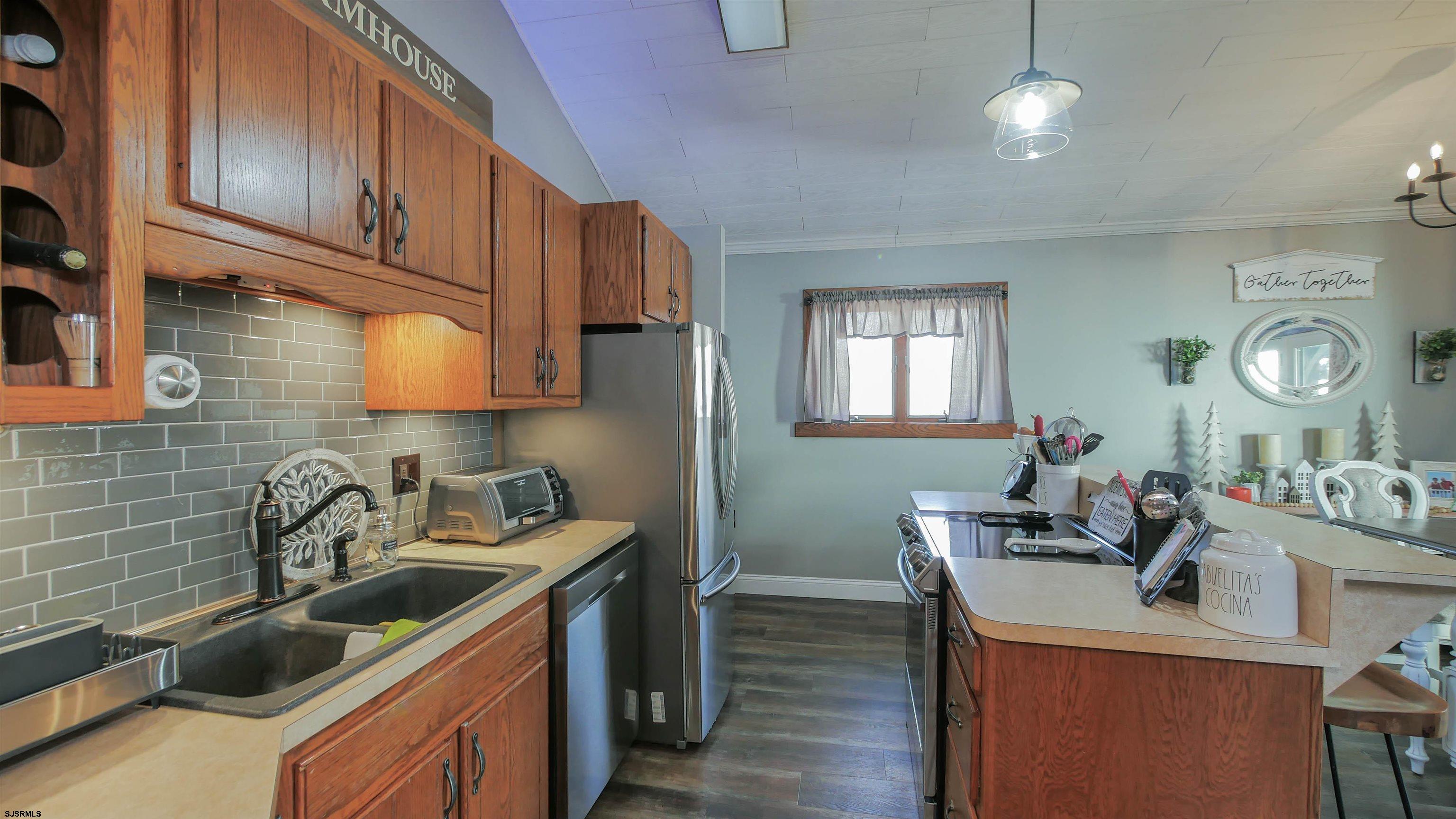 337 Broad Street Milmay, NJ 08330 - Photo 21 of 36 a kitchen that has a sink and a stove