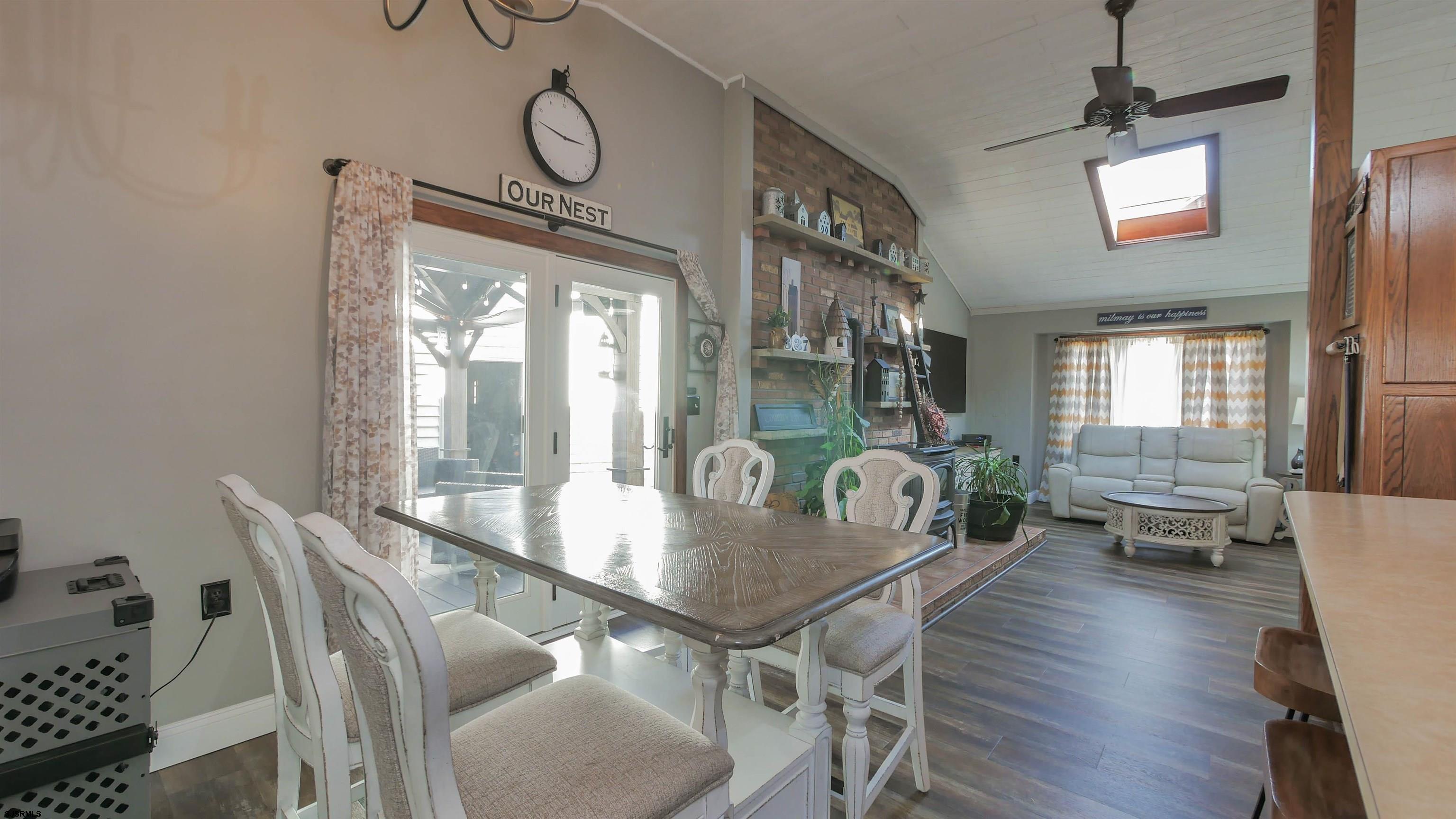 337 Broad Street Milmay, NJ 08330 - Photo 23 of 36 a dining room with furniture a chandelier and wooden floor