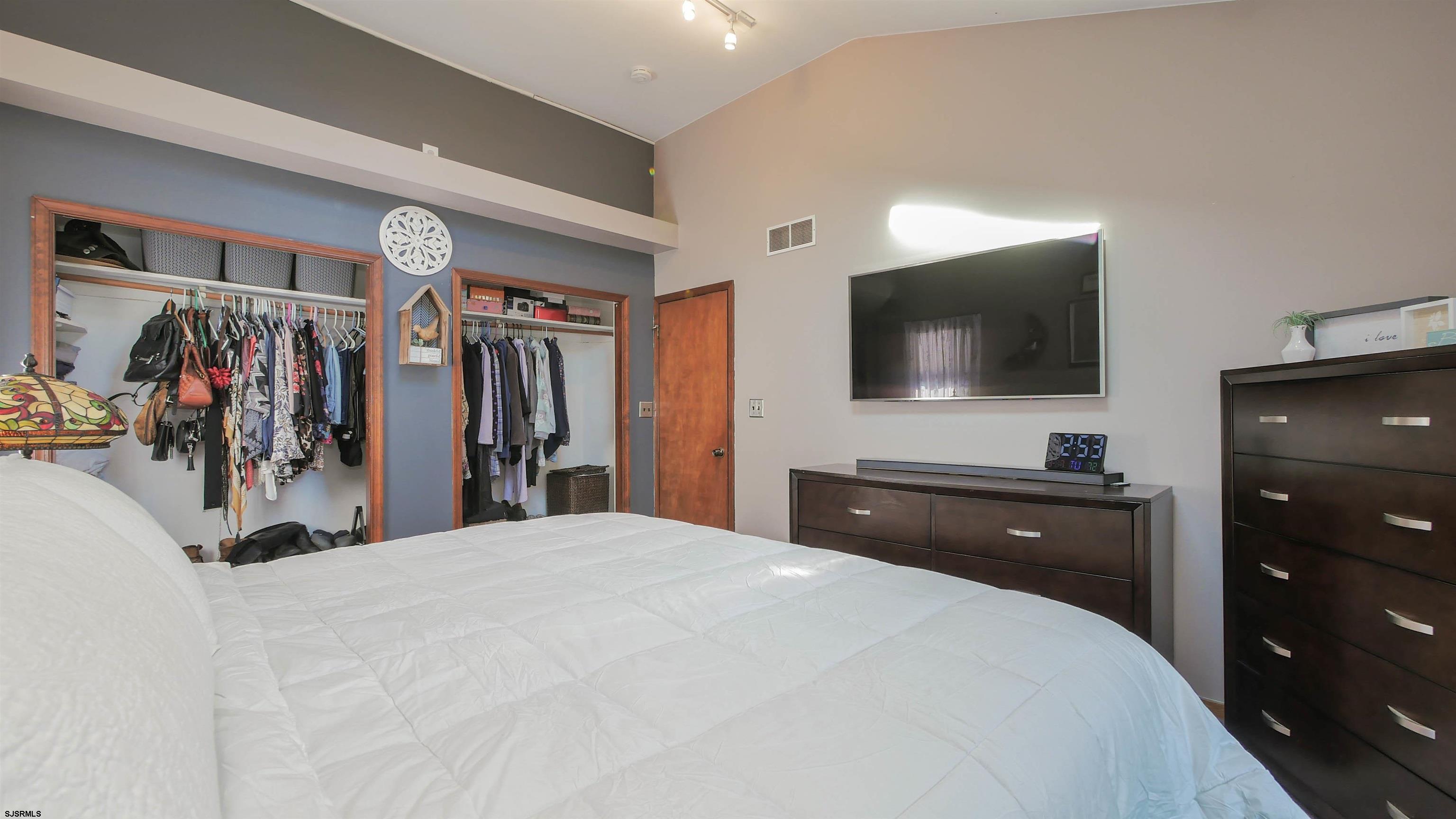 337 Broad Street Milmay, NJ 08330 - Photo 26 of 36 a bedroom with a bed a flat screen tv and a large mirror
