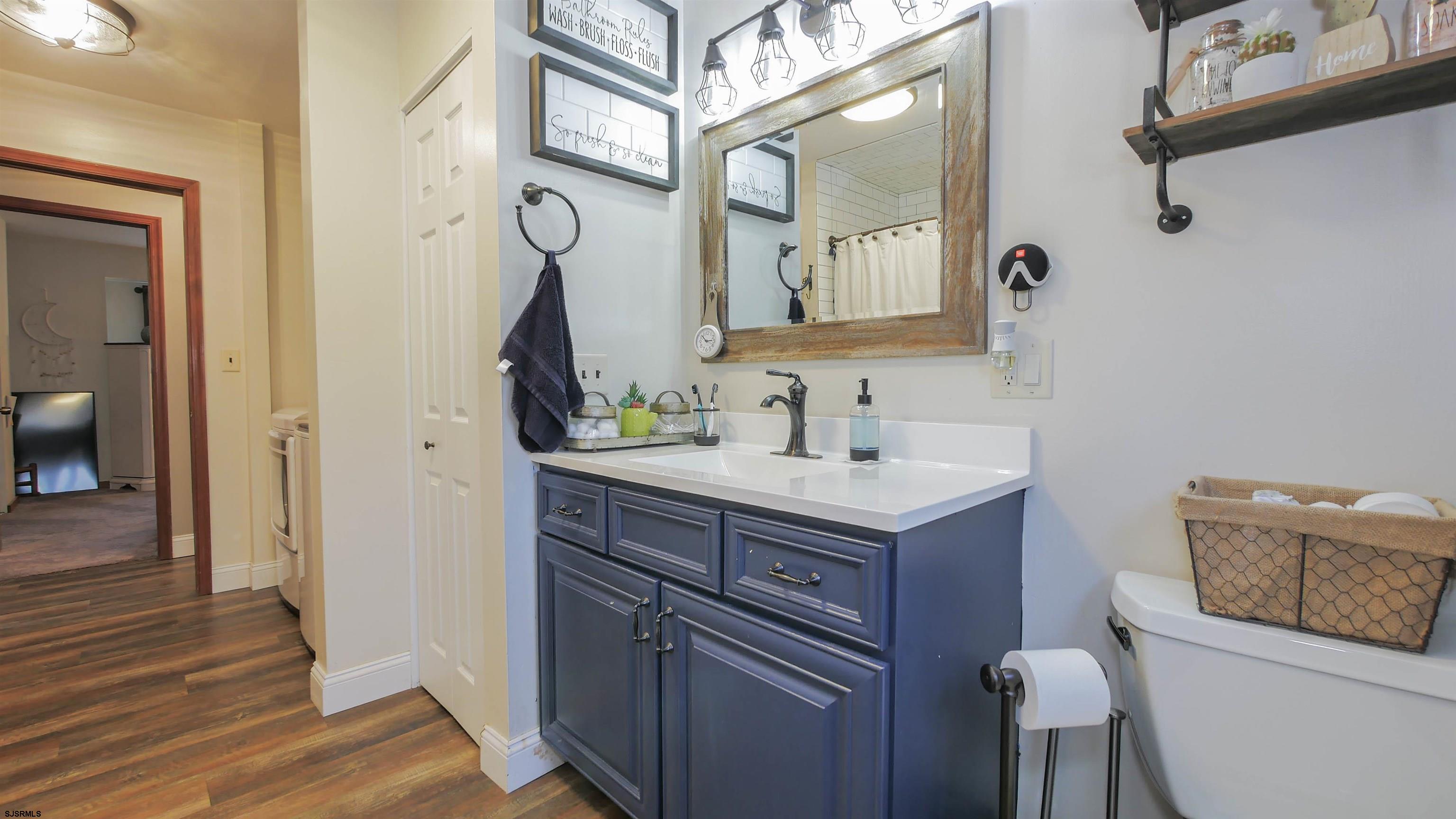 337 Broad Street Milmay, NJ 08330 - Photo 28 of 36 a bathroom with a sink a toilet and mirror