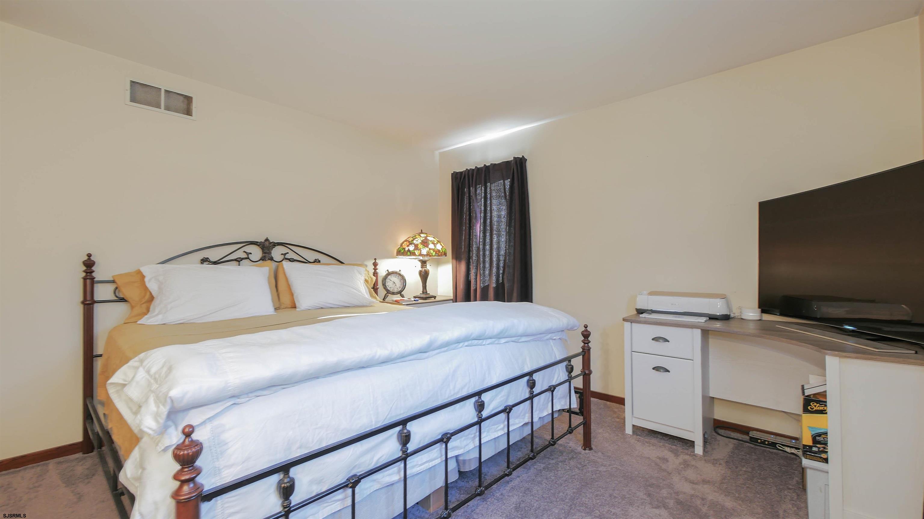 337 Broad Street Milmay, NJ 08330 - Photo 31 of 36 a bedroom with a bed and tv on the dresser
