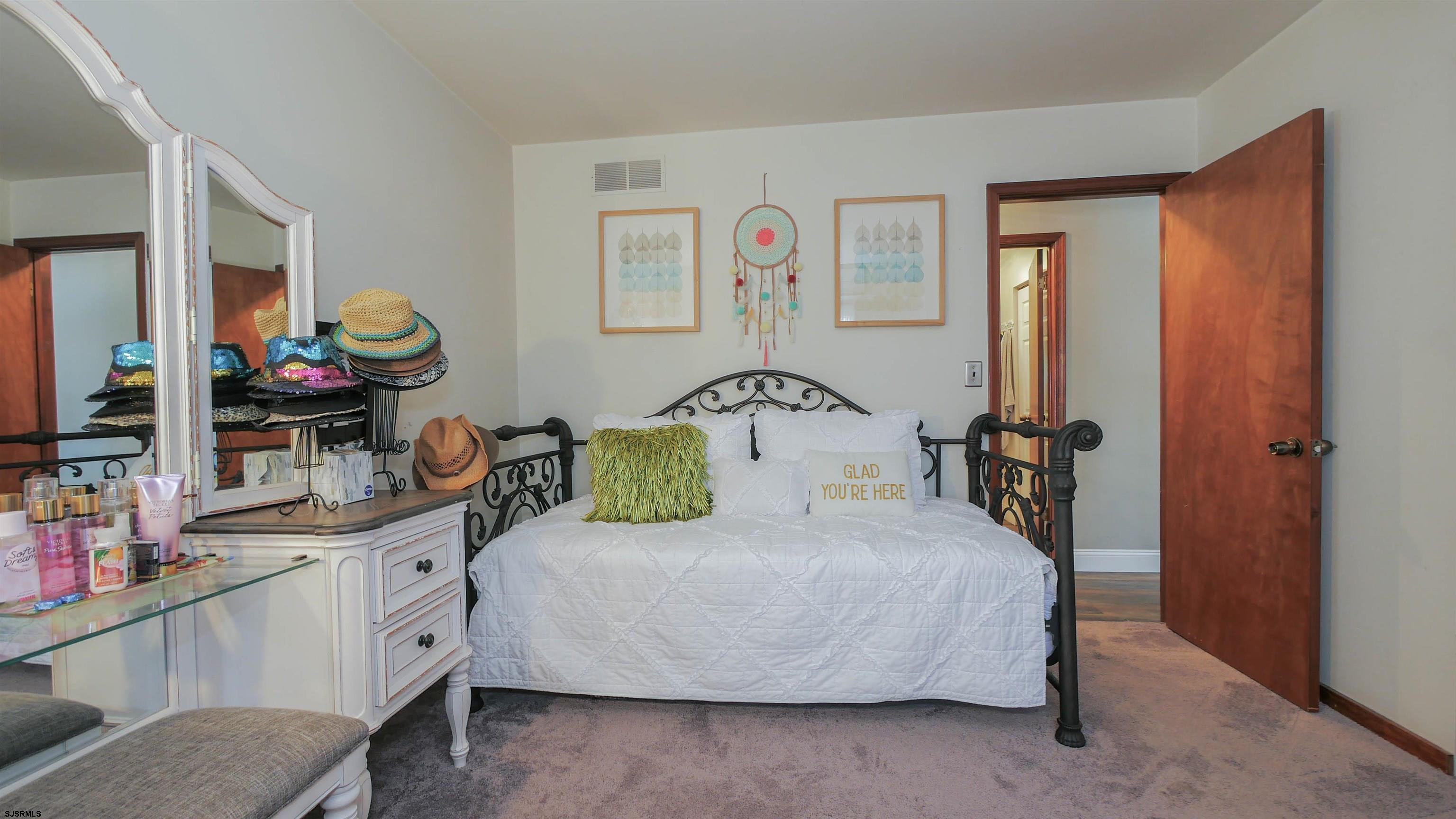 337 Broad Street Milmay, NJ 08330 - Photo 32 of 36 a bedroom with a bed and dresser with mirror