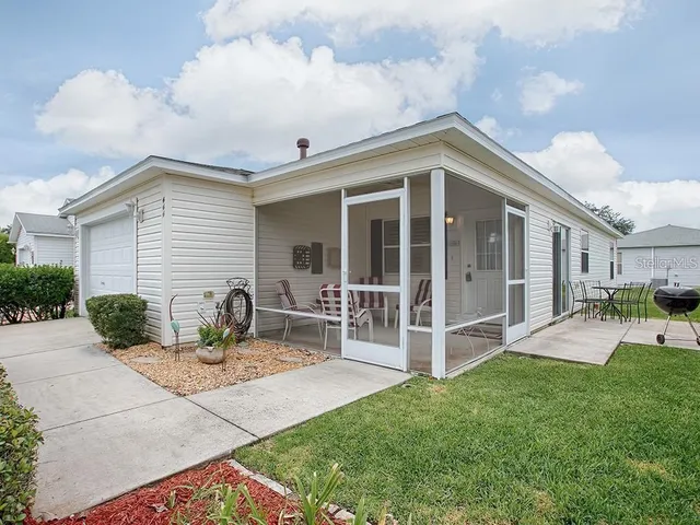 a view of a house with backyard porch and sitting area