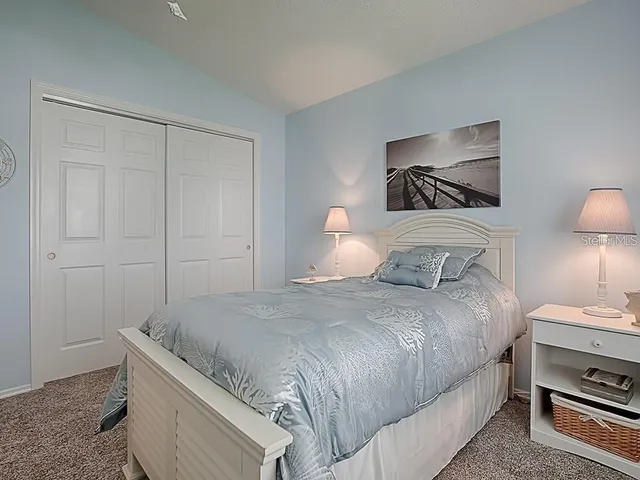 a bathroom with a granite countertop sink a toilet and a shower curtain
