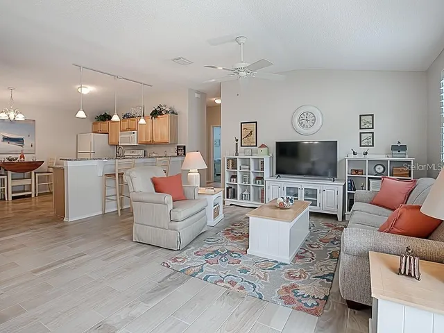 a living room with fireplace furniture and a large window