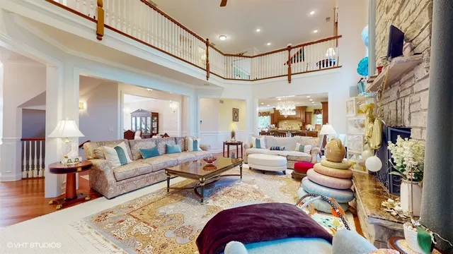 a view of a dining room with furniture a chandelier and wooden floor