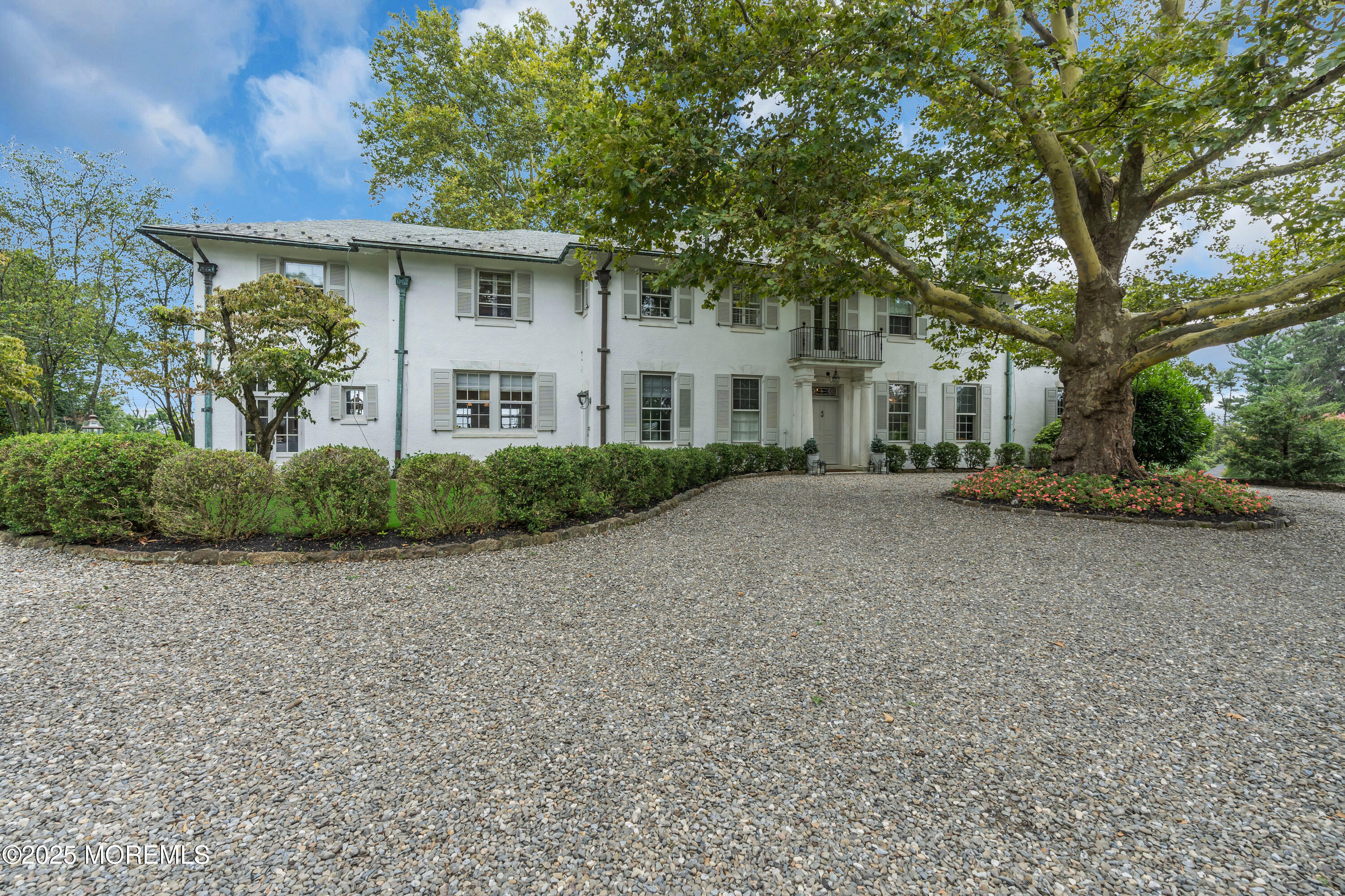 809 Navesink River Road Rumson, NJ 07760 - Photo 11 of 45 a front view of a house with a garden
