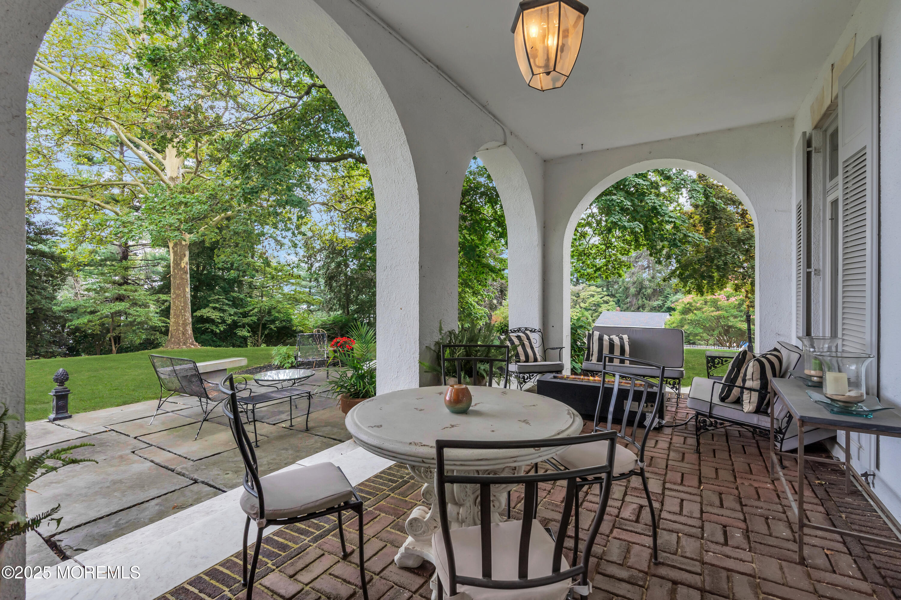 809 Navesink River Road Rumson, NJ 07760 - Photo 33 of 45 a view of a patio with table and chairs potted plants with wooden floor