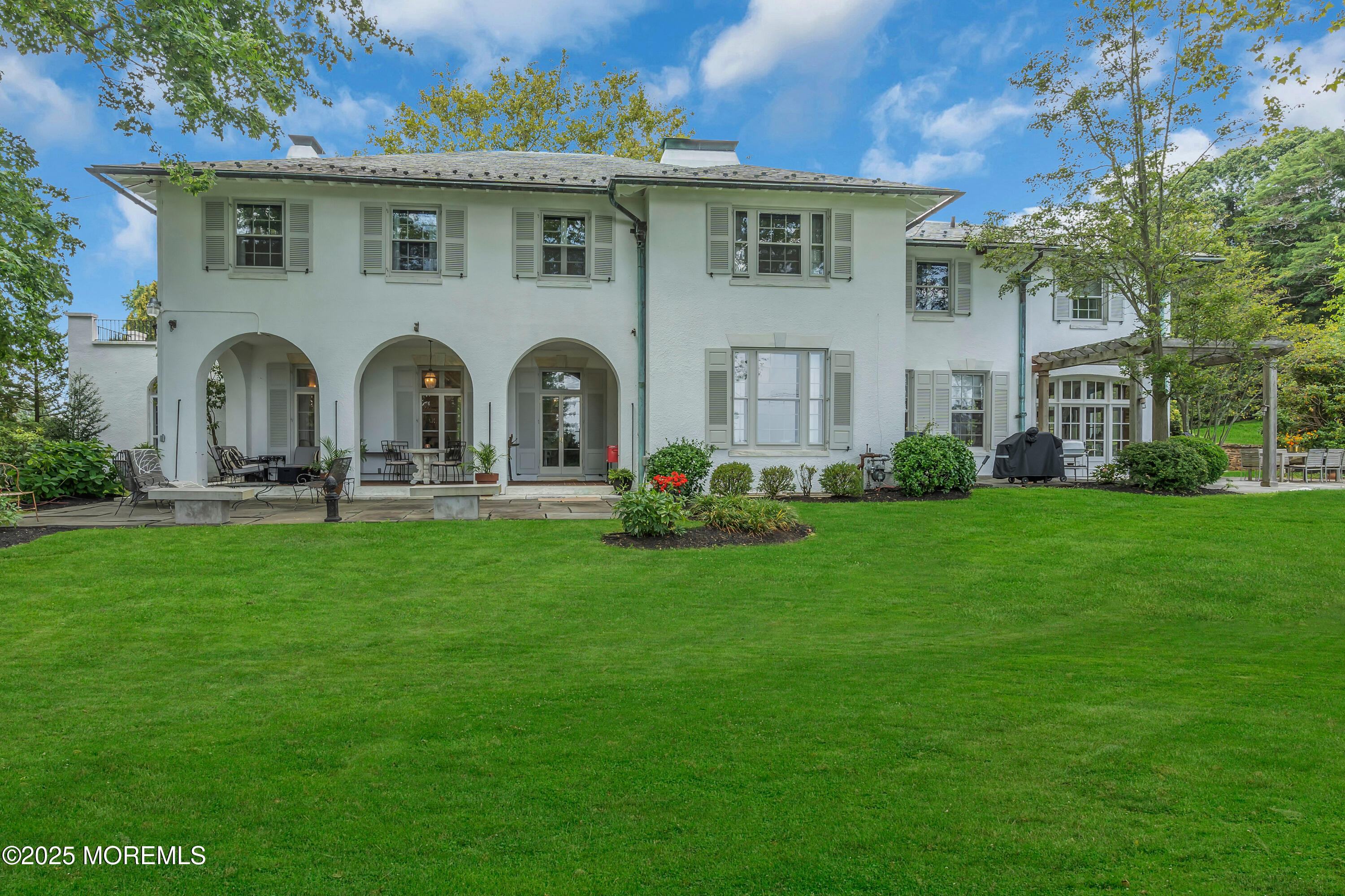 809 Navesink River Road Rumson, NJ 07760 - Photo 9 of 45 a front view of house with garden