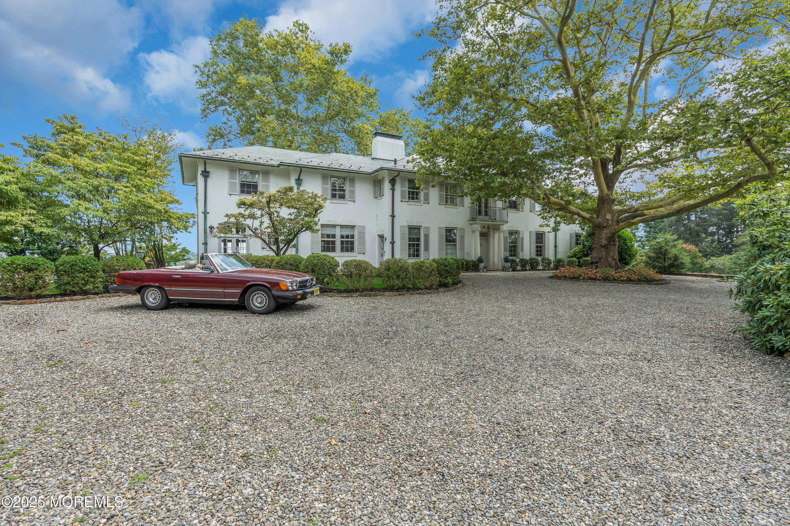 809 Navesink River Road Rumson, NJ 07760 - Photo 10 of 45 a front view of a house with a garden