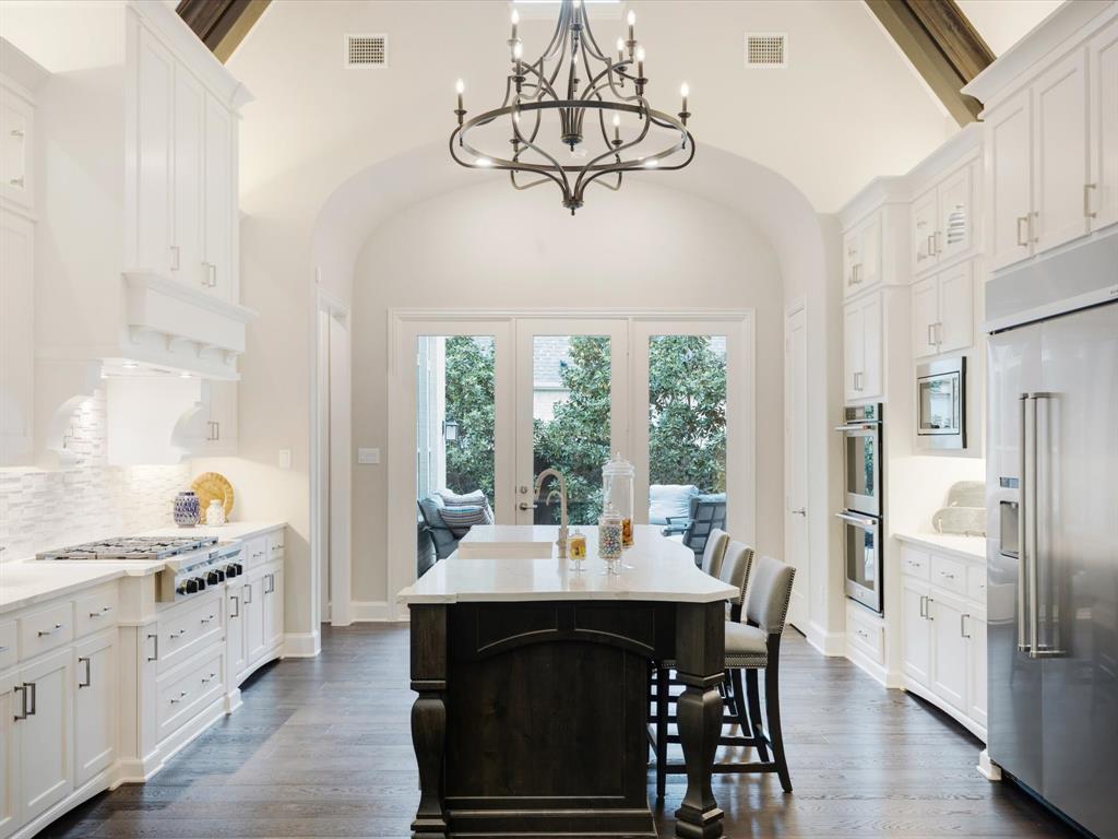 621 Hawk Wood Lane Prosper, TX 75078 - Photo 18 of 40 a dining room with wooden floor and large windows