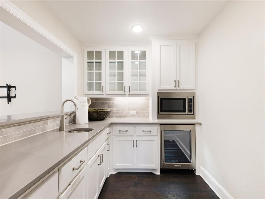 621 Hawk Wood Lane Prosper, TX 75078 - Photo 24 of 40 a kitchen with granite countertop white cabinets stainless steel appliances and sink