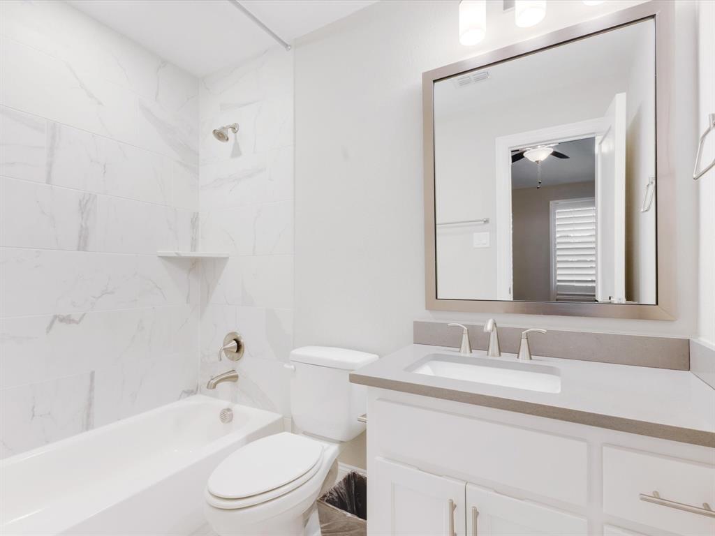 621 Hawk Wood Lane Prosper, TX 75078 - Photo 27 of 40 a bathroom with a sink toilet vanity and shower