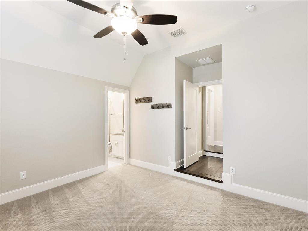 621 Hawk Wood Lane Prosper, TX 75078 - Photo 30 of 40 an empty room with closet and a chandelier fan