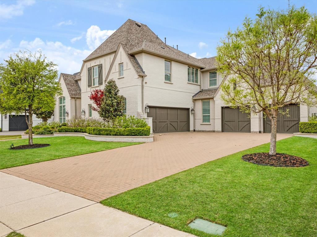 621 Hawk Wood Lane Prosper, TX 75078 - Photo 3 of 40 a front view of a house with a yard and trees