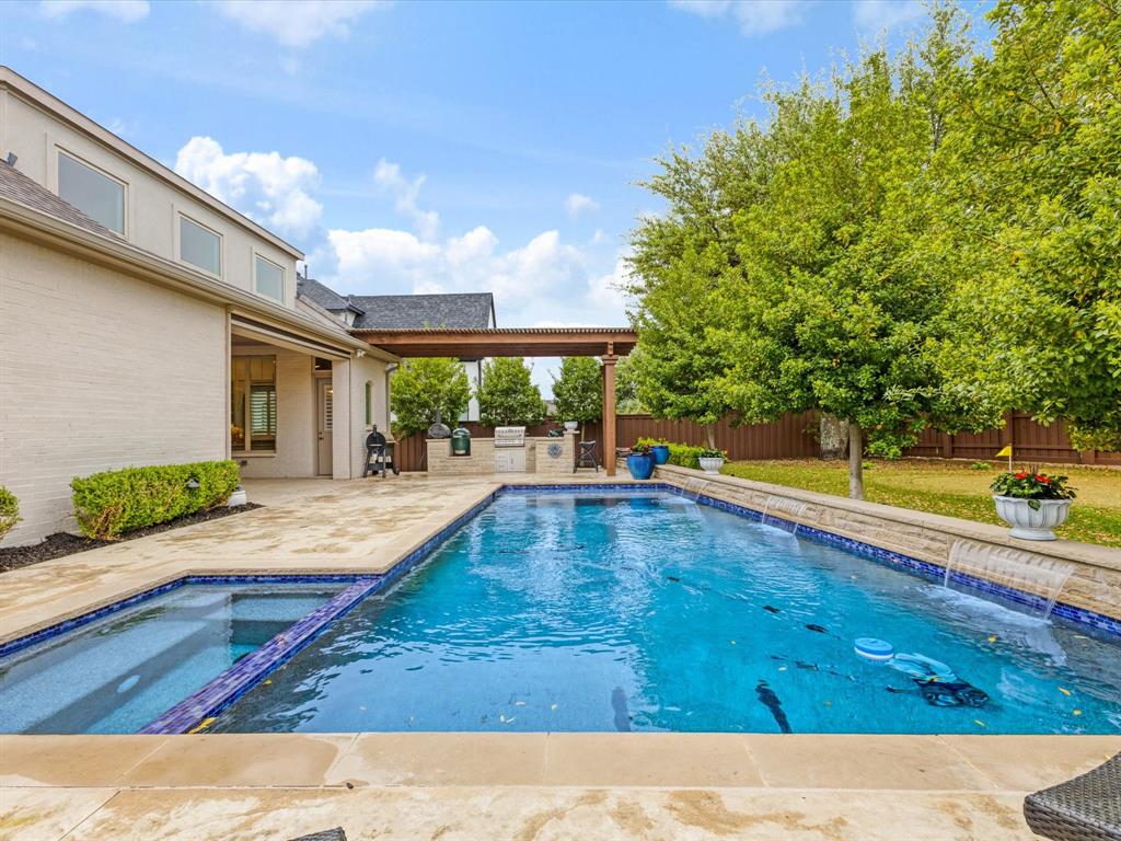 621 Hawk Wood Lane Prosper, TX 75078 - Photo 35 of 40 a view of a swimming pool with an outdoor space