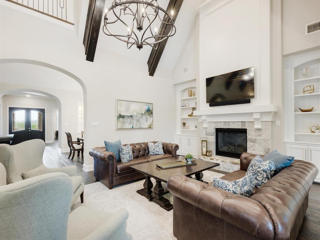 621 Hawk Wood Lane Prosper, TX 75078 - Photo 9 of 40 a living room with furniture fireplace and flat screen tv