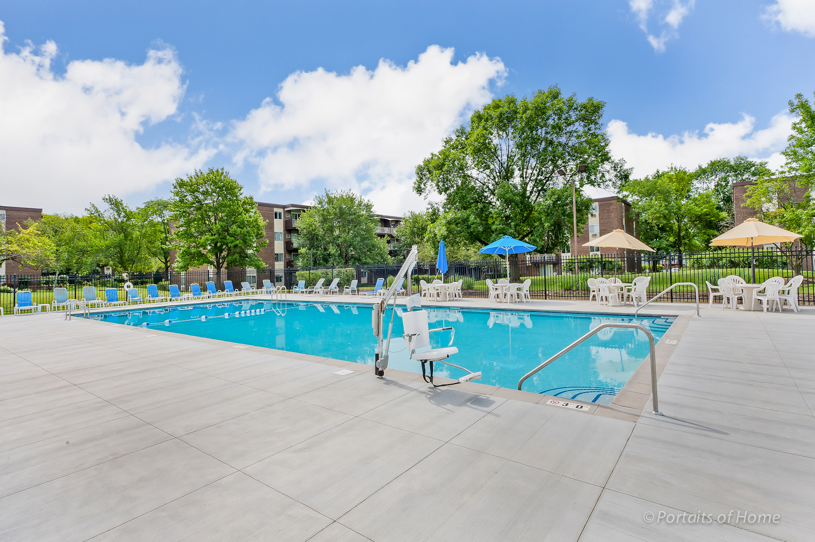 1301 South Finley Road, Unit 114 Lombard, IL 60148 - Photo 12 of 12 a view of swimming pool with outdoor seating and trees in the background