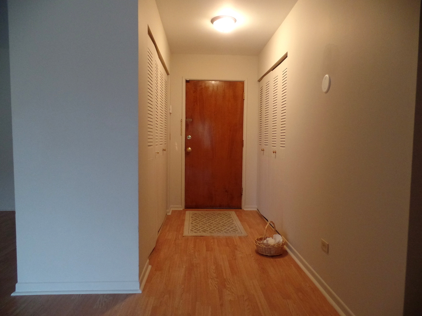 1301 South Finley Road, Unit 114 Lombard, IL 60148 - Photo 2 of 12 a view of hallway with wooden floor