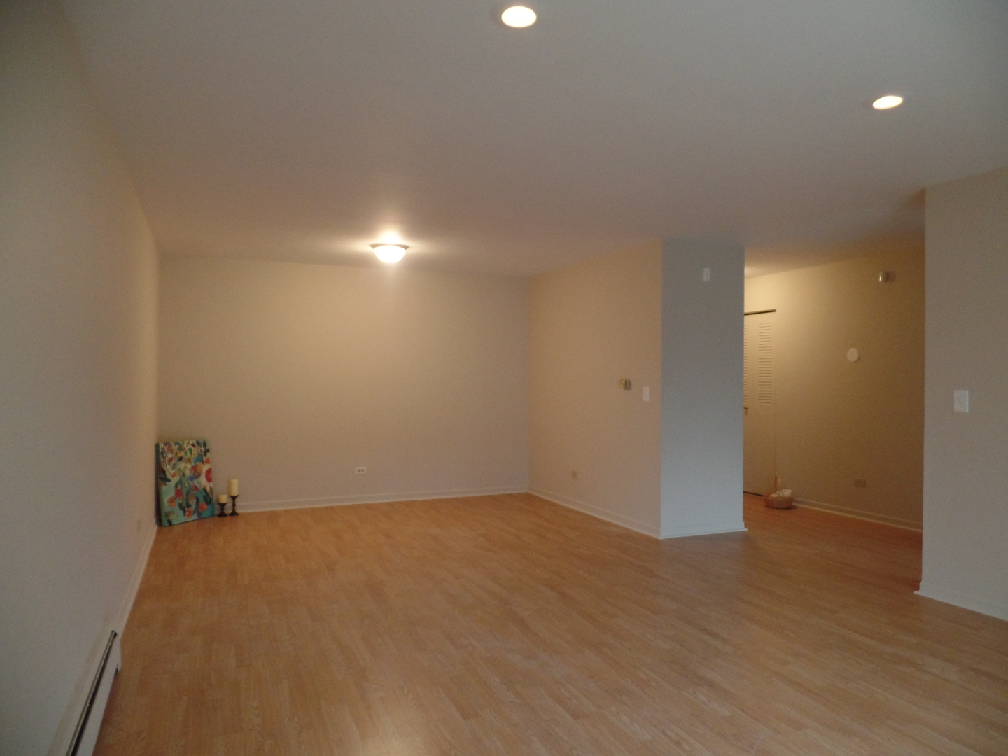 1301 South Finley Road, Unit 114 Lombard, IL 60148 - Photo 3 of 12 an empty room with wooden floor and windows