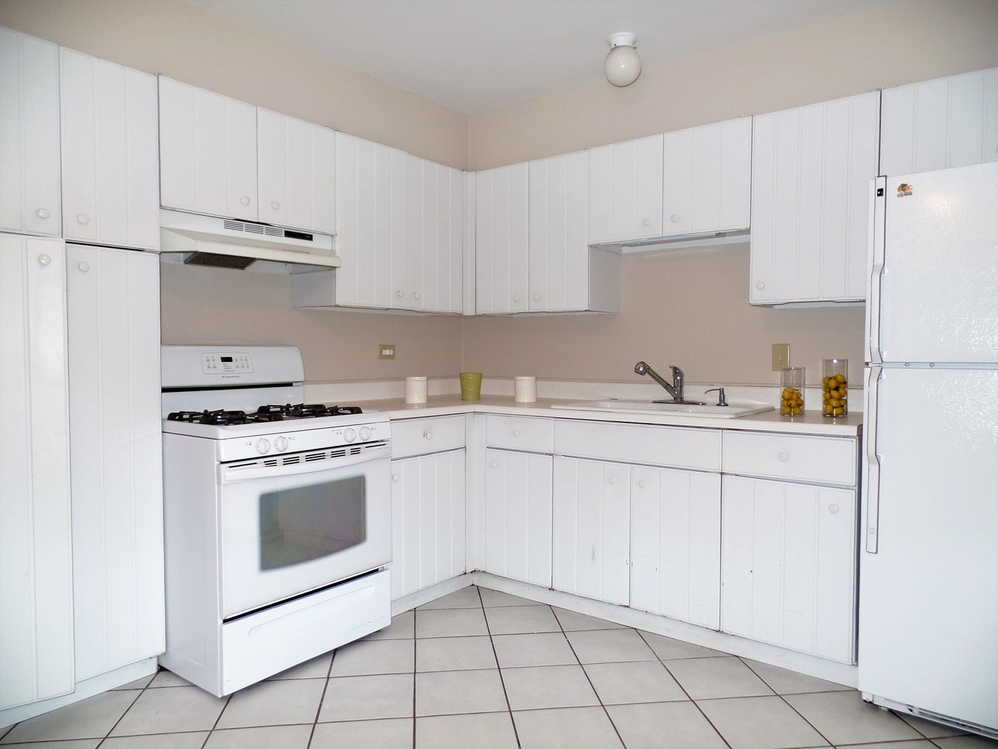 1301 South Finley Road, Unit 114 Lombard, IL 60148 - Photo 6 of 12 a kitchen with granite countertop white cabinets and white appliances