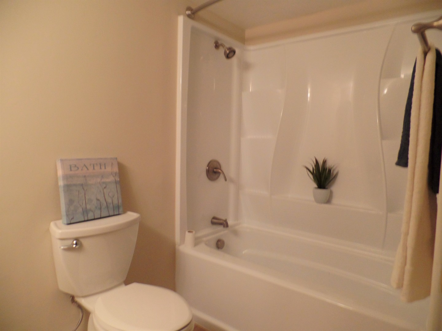 1301 South Finley Road, Unit 114 Lombard, IL 60148 - Photo 10 of 12 a white toilet sitting next to a bath tub