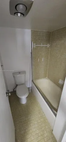 a bathroom with a double vanity sink toilet and mirror