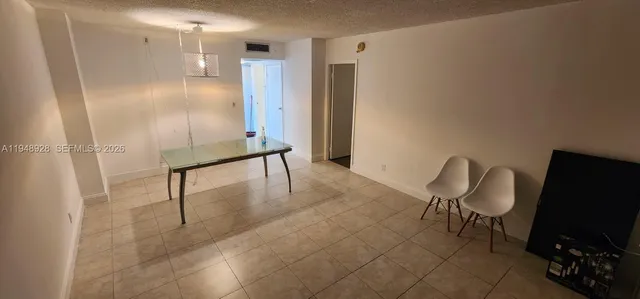 a room with a chair and a flat screen tv