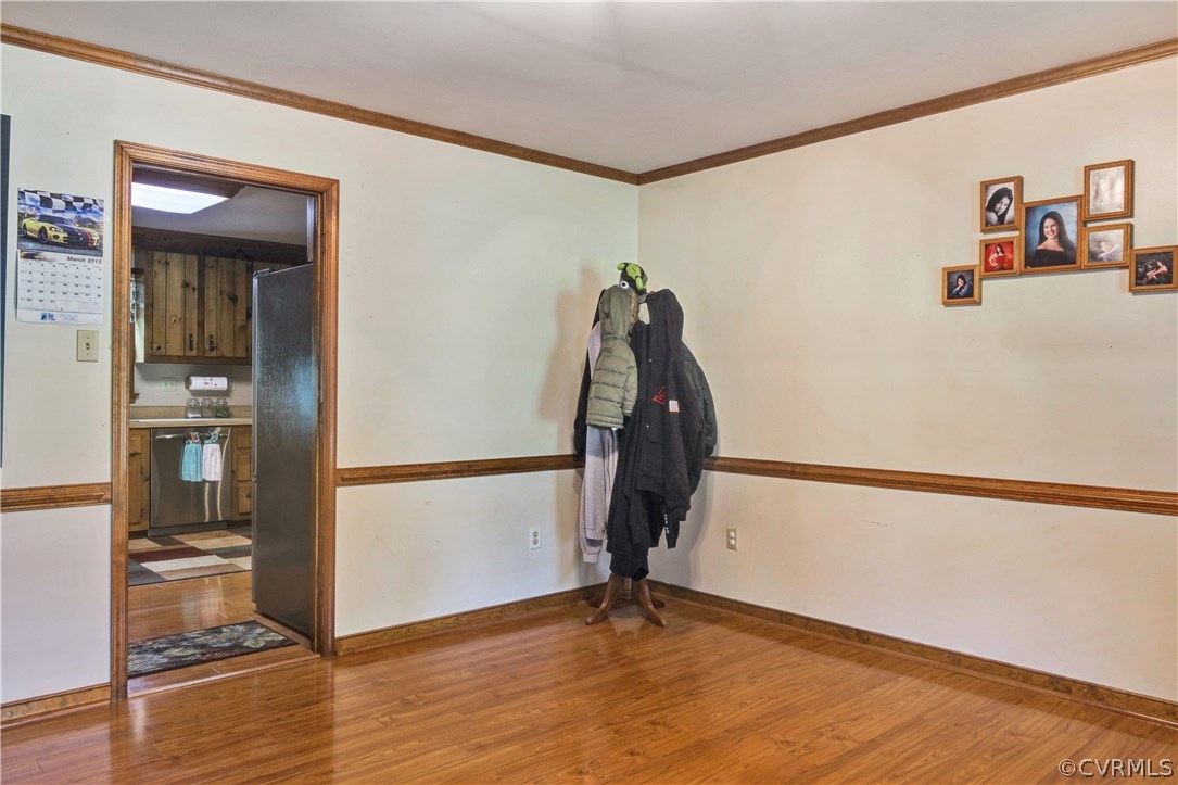15100 Beach Road Chesterfield, VA 23838 - Photo 4 of 41 a view of a room with wooden floor and a refrigerator
