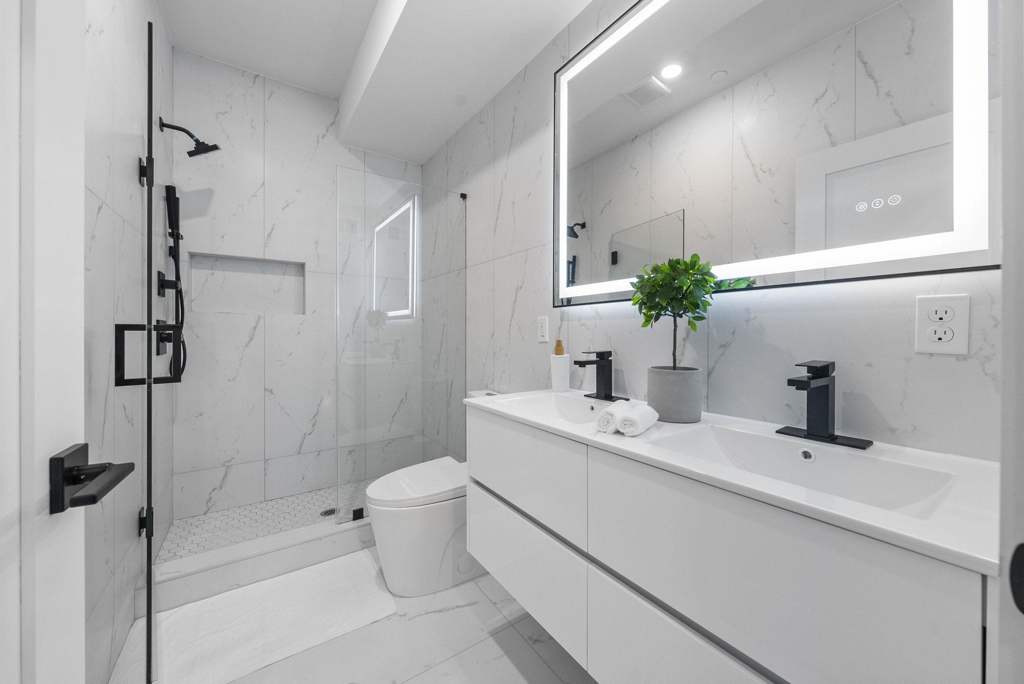 124 Glenwood Avenue Jersey City, NJ 07306 - Photo 11 of 42 a bathroom with a sink a toilet and shower