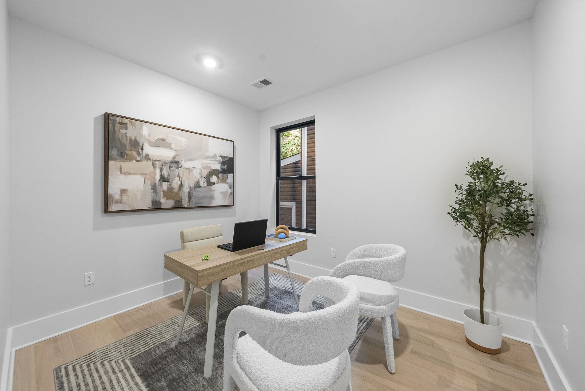 124 Glenwood Avenue Jersey City, NJ 07306 - Photo 15 of 42 a living room with furniture and a potted plant