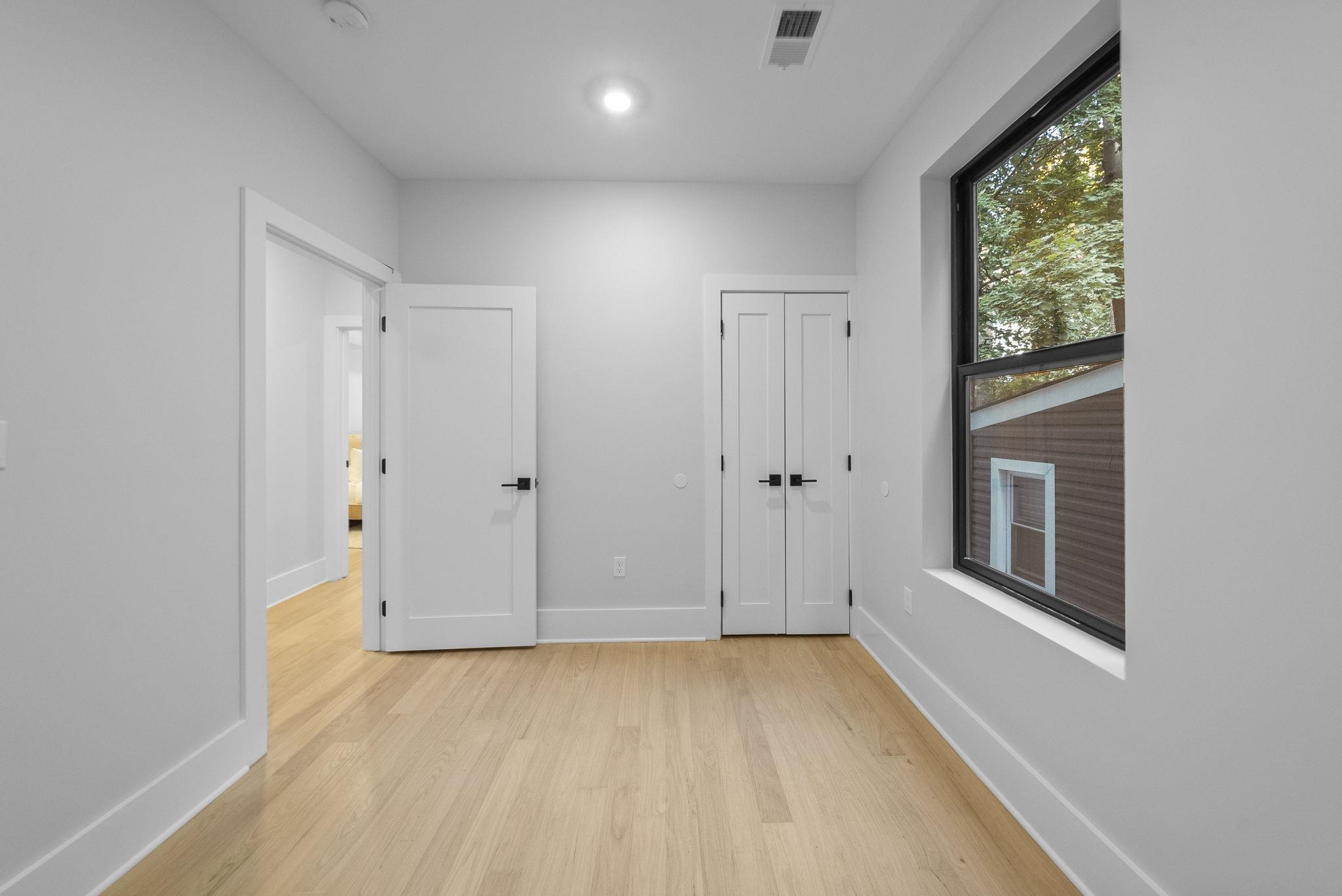 124 Glenwood Avenue Jersey City, NJ 07306 - Photo 17 of 42 a view of an empty room with a window and closet area