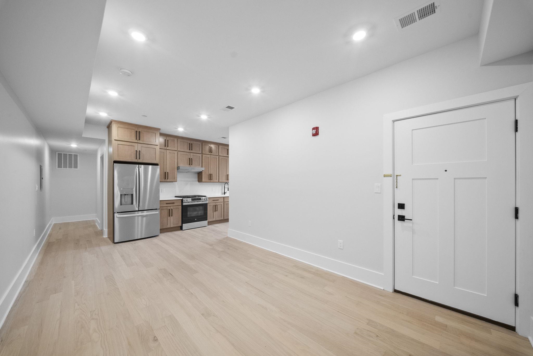 124 Glenwood Avenue Jersey City, NJ 07306 - Photo 19 of 42 a kitchen with stainless steel appliances a refrigerator and microwave