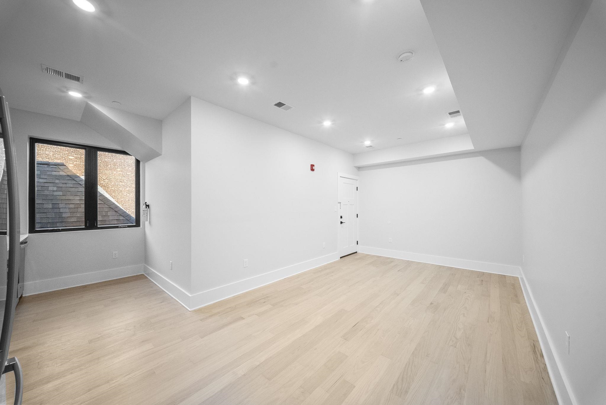 124 Glenwood Avenue Jersey City, NJ 07306 - Photo 20 of 42 an empty room with large windows