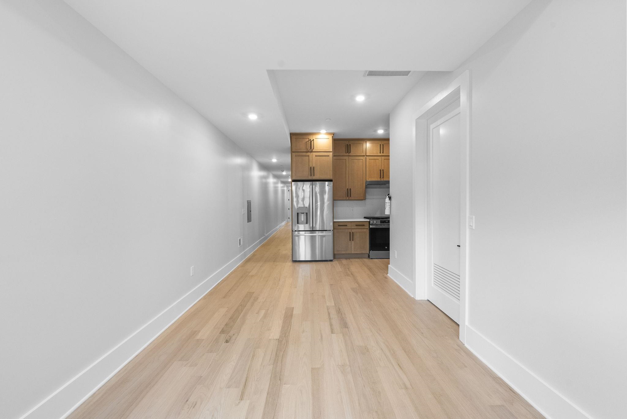 124 Glenwood Avenue Jersey City, NJ 07306 - Photo 28 of 42 a view of empty room with wooden floor