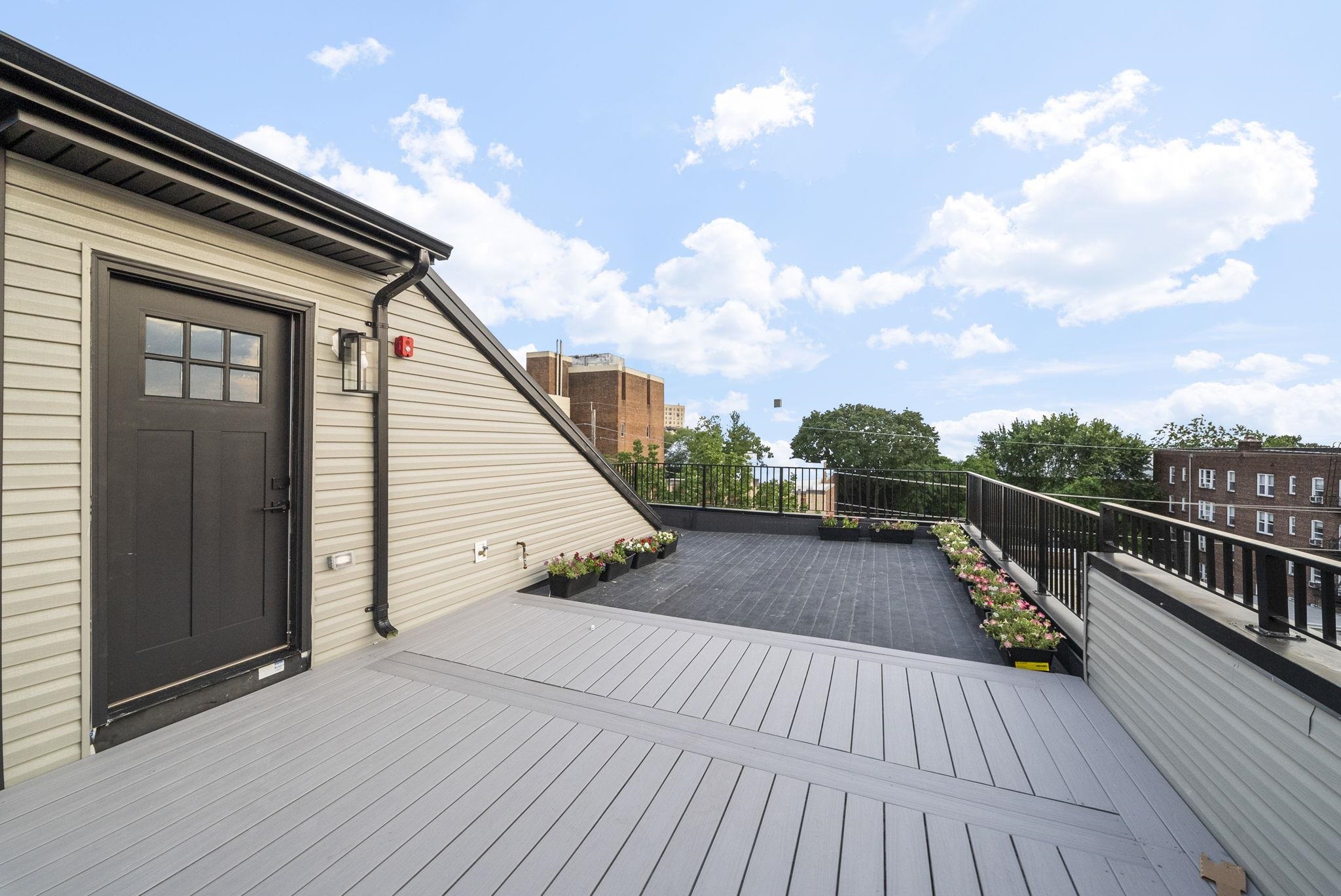 124 Glenwood Avenue Jersey City, NJ 07306 - Photo 32 of 42 a view of balcony and deck with wooden floor
