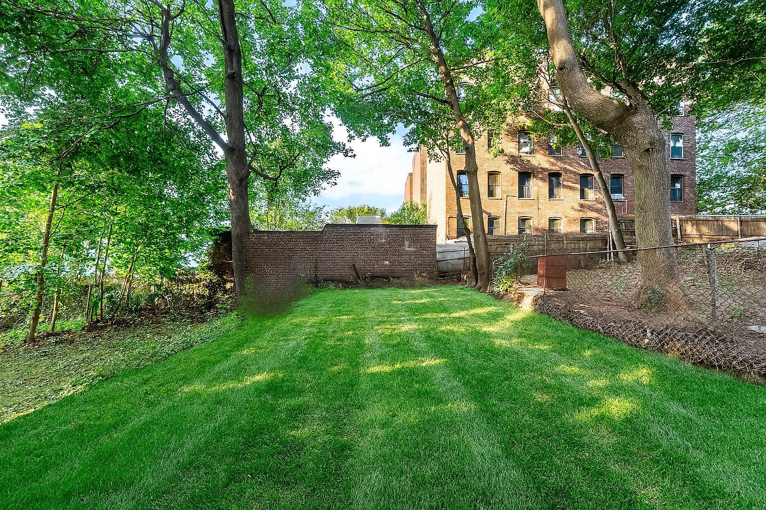 124 Glenwood Avenue Jersey City, NJ 07306 - Photo 36 of 42 a view of a backyard with large tree