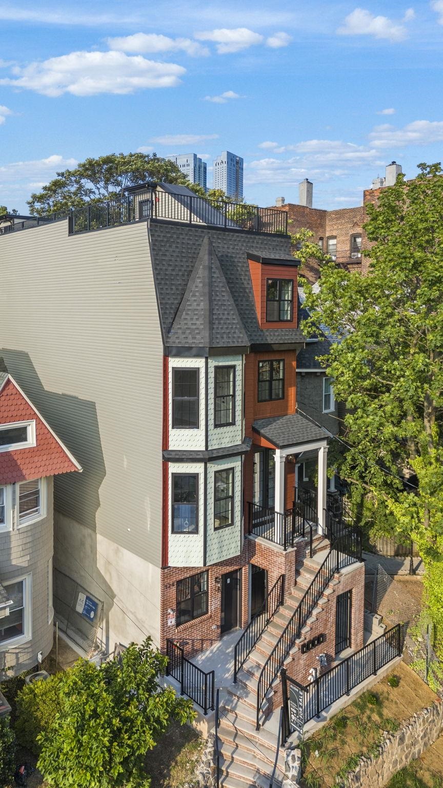 124 Glenwood Avenue Jersey City, NJ 07306 - Photo 38 of 42 a aerial view of a house with a yard and balcony