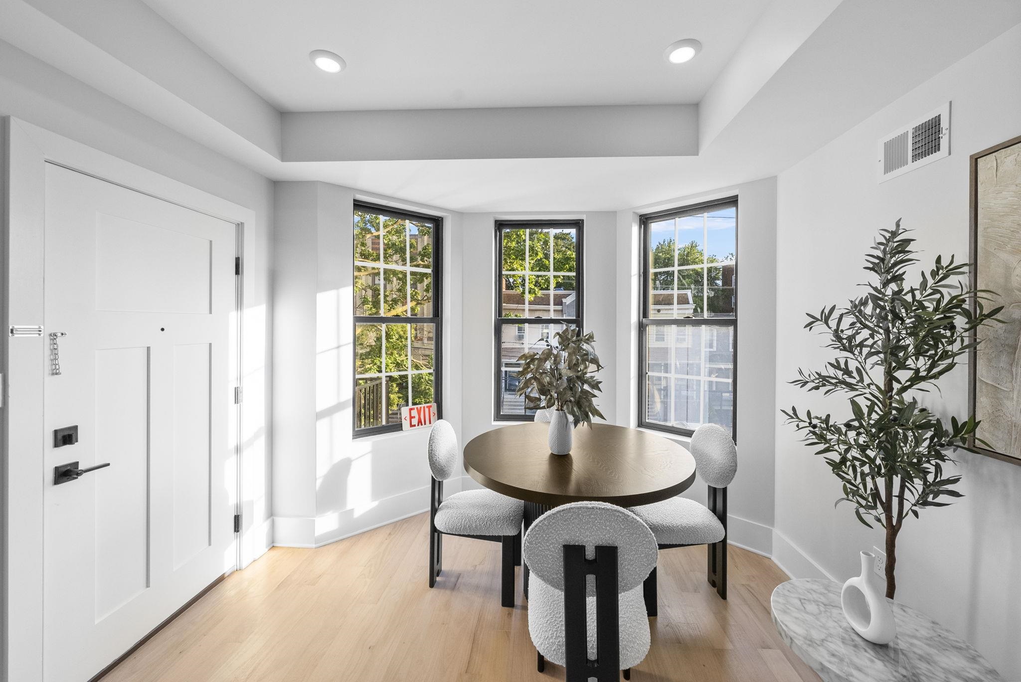 124 Glenwood Avenue Jersey City, NJ 07306 - Photo 6 of 42 a view of a dining room with furniture window and wooden floor
