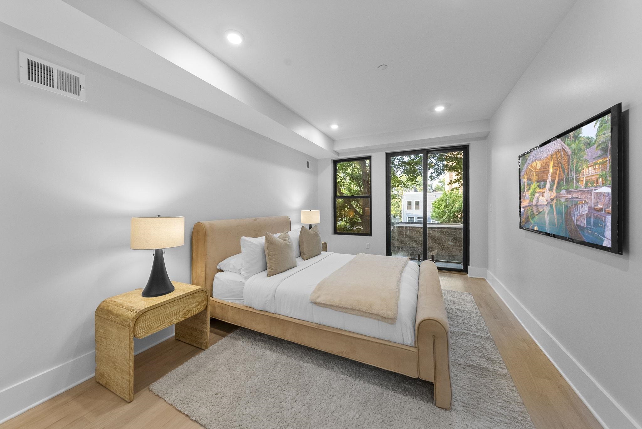 124 Glenwood Avenue Jersey City, NJ 07306 - Photo 8 of 42 a bedroom with a bed and lamp