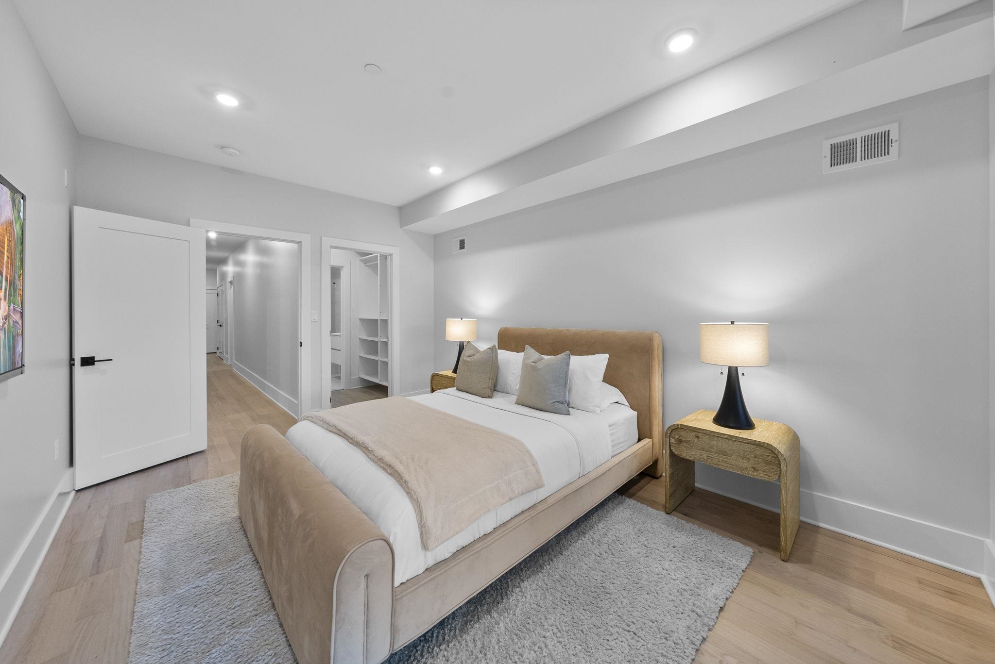 124 Glenwood Avenue Jersey City, NJ 07306 - Photo 9 of 42 a bedroom with a bed and a lamp