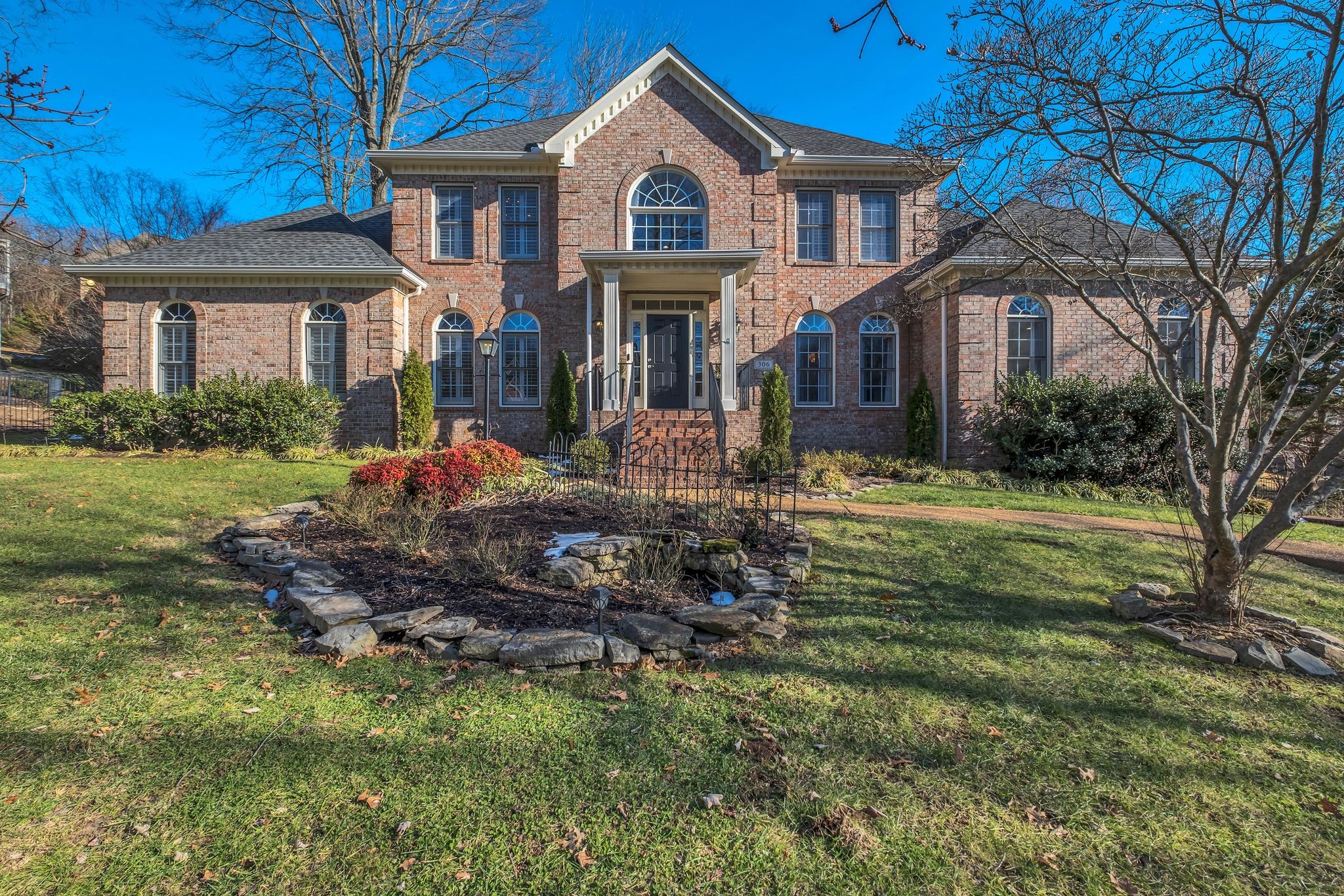a front view of a house with a yard