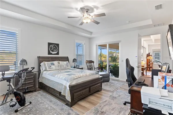a bedroom with a bed a large window and chair